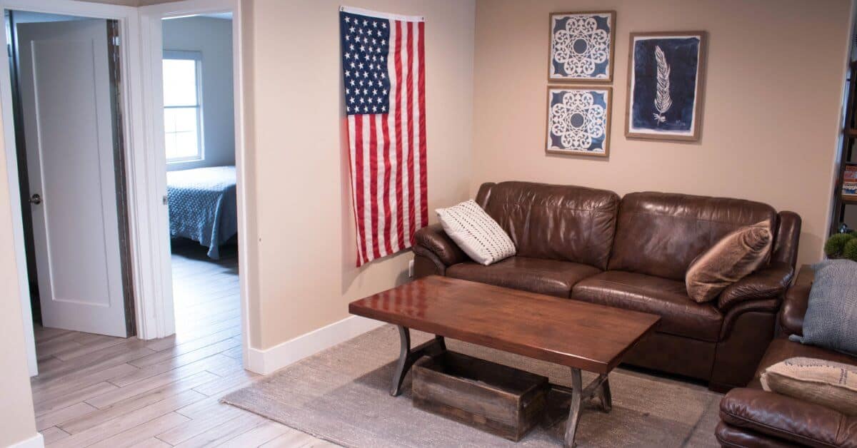 Experience Recovery | Living room with USA flag hanging on the wall