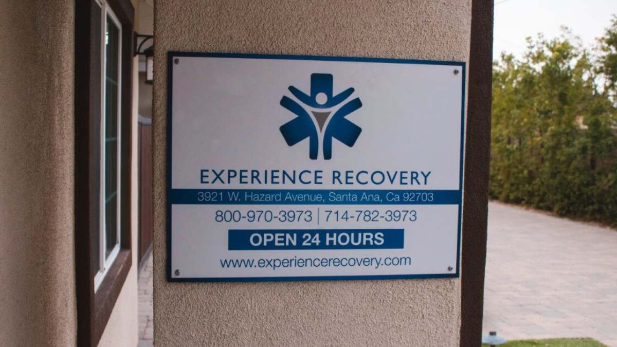 Informational board at the entrance of Experience Recovery's facility, including contact information, hours of operation, and website. This way, people needing heroin detox in Orange County can get in touch to start their treatment.